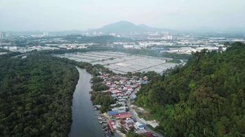 Fly over fish farm and fishign vilalge. Background is Bukit Mertajam Hill. video