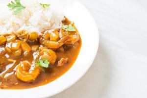 Shrimps in curry sauce on rice photo