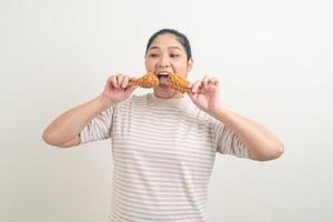 Asian woman with fried chicken on hand photo