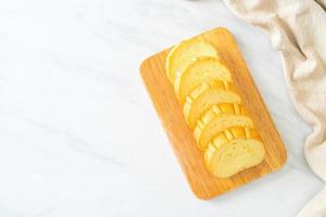 Pan de patatas en rodajas sobre tablero de madera foto