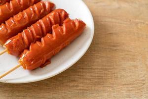 fried sausage skewer on plate photo