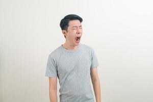 young Asian man with yawn face photo