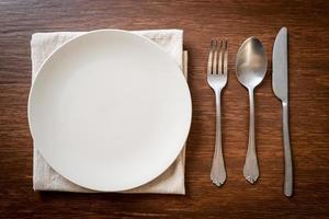 empty plate or dish with knife, fork and spoon photo