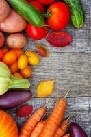 Assortment different fresh organic vegetables on country style wooden background. Healthy food vegan vegetarian dieting concept. Local garden produce clean food. Frame top view flat lay copy space. photo