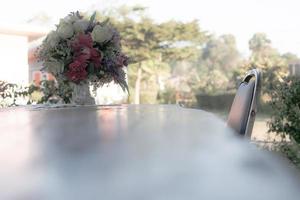 Chair and tables with vases placed flowers on the table in the front garden photo