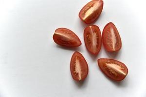 Sliced red tomato on a white background photo