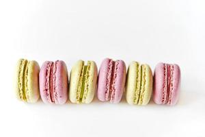 Delicious multicolored almond cookies isolated on a white background. Sweet multicolored macaroons. photo