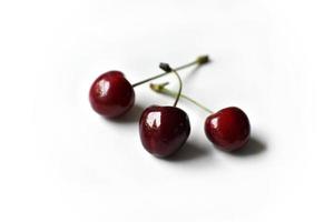 Juicy red ripe cherries on a white background. photo