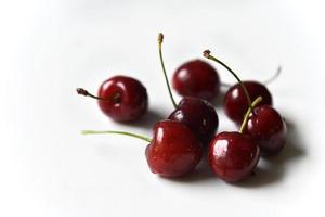 Juicy red ripe cherries on a white background. photo