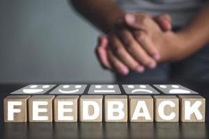 Welcome gesture of Receptionist with feedback blocks and emoji face. photo