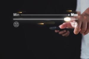 Evaluation and satisfaction concept. Feedback level from min to max. Close up shot on index finger that points to maximum score. photo