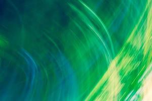 Bright abstract background in shades of green with a gradient and glowing stripes photo