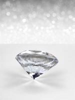 Diamonds of placed on white shining bokeh background. concept for selection best diamond gem design photo