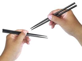 Hand holding wooden chopsticks isolated on white background photo