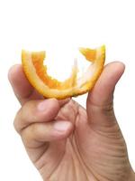 hand holding slice of orange isolated on white background photo