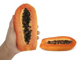 Male hand holding a half of ripe papaya isolated on white background photo