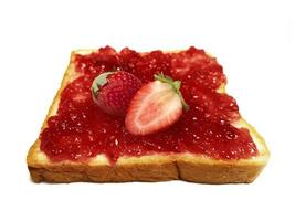 Fresh strawberry on slice of bread with strawberry jam isolated on white photo