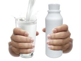 hand with glass of milk and milk bottle on a white background photo