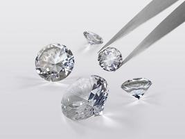 brilliant cut diamond held by tweezers photo