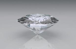 Shiny brilliant diamond placed on gray background photo