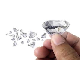 Diamond jewel in hand, isolated on white background photo