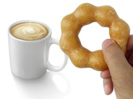 donut en la mano del hombre y café caliente aislado sobre fondo blanco. foto