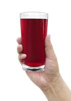 hand holding of pomegranate juice in a glass. with on white background photo