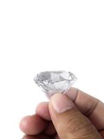 Diamond jewel in hand, isolated on white background photo