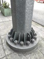Fasteners - screws and nuts on the base of the electric post from metal photo