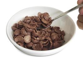 dry breakfast in a plate on a white background. Chocolate cereals photo