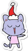 sticker cartoon of a cat singing wearing santa hat vector