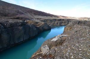 Large river flowing through large rock formations photo