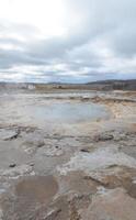 Steaming geyser with blue skies in the background photo