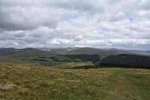 Beautiful Scenic Rolling Hills Under Thick Clouds photo