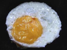 fried egg on black background photo