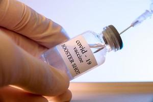 COVID-19 booster vaccine vial. Medicine and health care concept photo