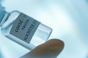 COVID-19 booster vaccine vial. Medicine and health care concept photo