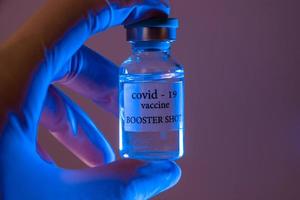 COVID-19 booster vaccine vial. Medicine and health care concept photo