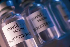 COVID-19 booster vaccine vial. Medicine and health care concept photo