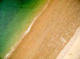 Background with greenish sea , golden and white sand photo