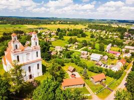 kurtuvenai, lituania, 2021 - vista aérea st. la iglesia de jacob el apóstol en la ciudad de kurtuvenai, con fondo panorámico del campo de lituania foto