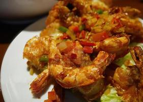 Close-up vibrant color of Roasted Chili and Salt shrimp deep fried prawns delicious local asian menu photo