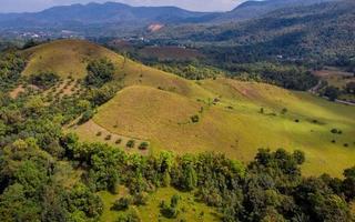 bald mountain or Phu Khao Ya with green grass field and blue sky. One of natural travel attraction in Ranong province, Thailand photo