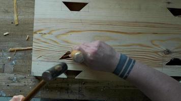 woodworker carving a dovetail eyelet with a chisel video