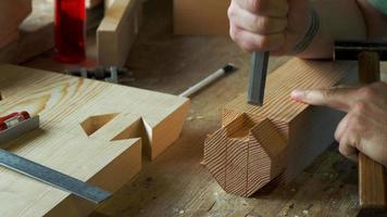 woodworker carving a dovetail eyelet with a chisel video