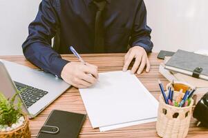 businessman examines the documents at the desk in the room photo