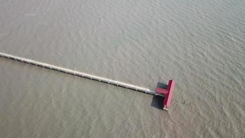 Aerial rotating look down Pantai Murni waterfront bridge at Yan, Kedah. video