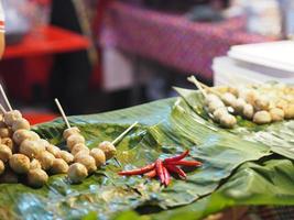 Pork grilled meat balls on leaves banana photo