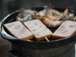 Shrimp Roasted steel pan on charcoal stove photo