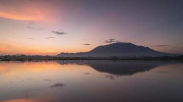 Timelapse reflection sunrise with golden cloud formation video